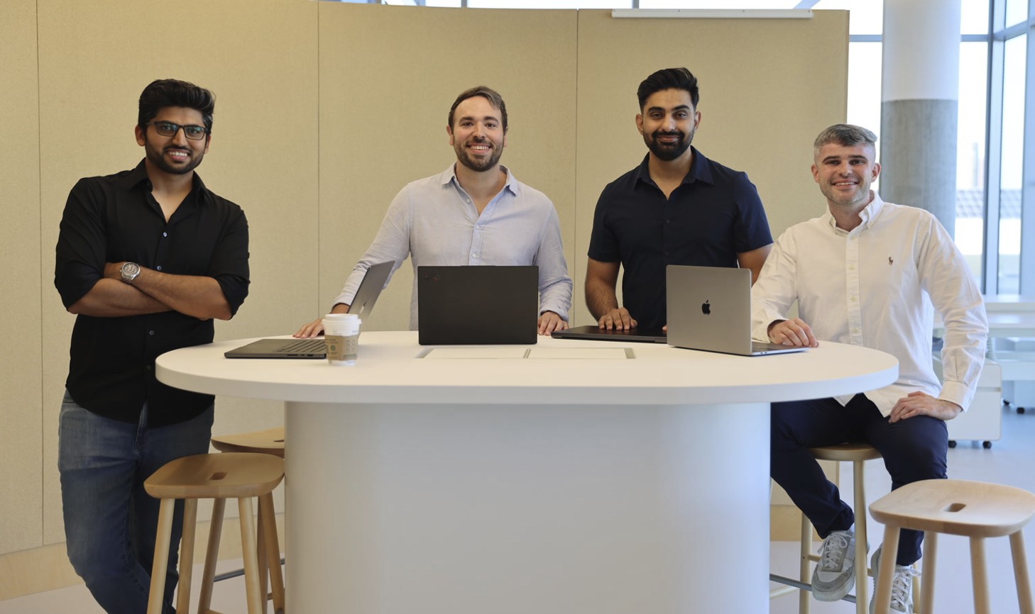 Lantern founding team gathered around a table with laptops